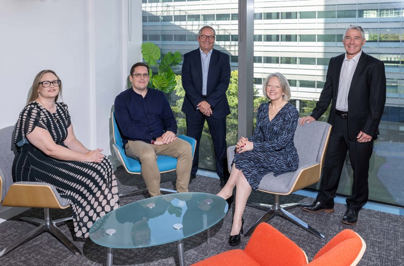 Emma Eccles, Lee Cook, Kieran Jones, Carole Spiller and Mark Woodall sit around a table in a conference room in Weightmans' Manchester office
